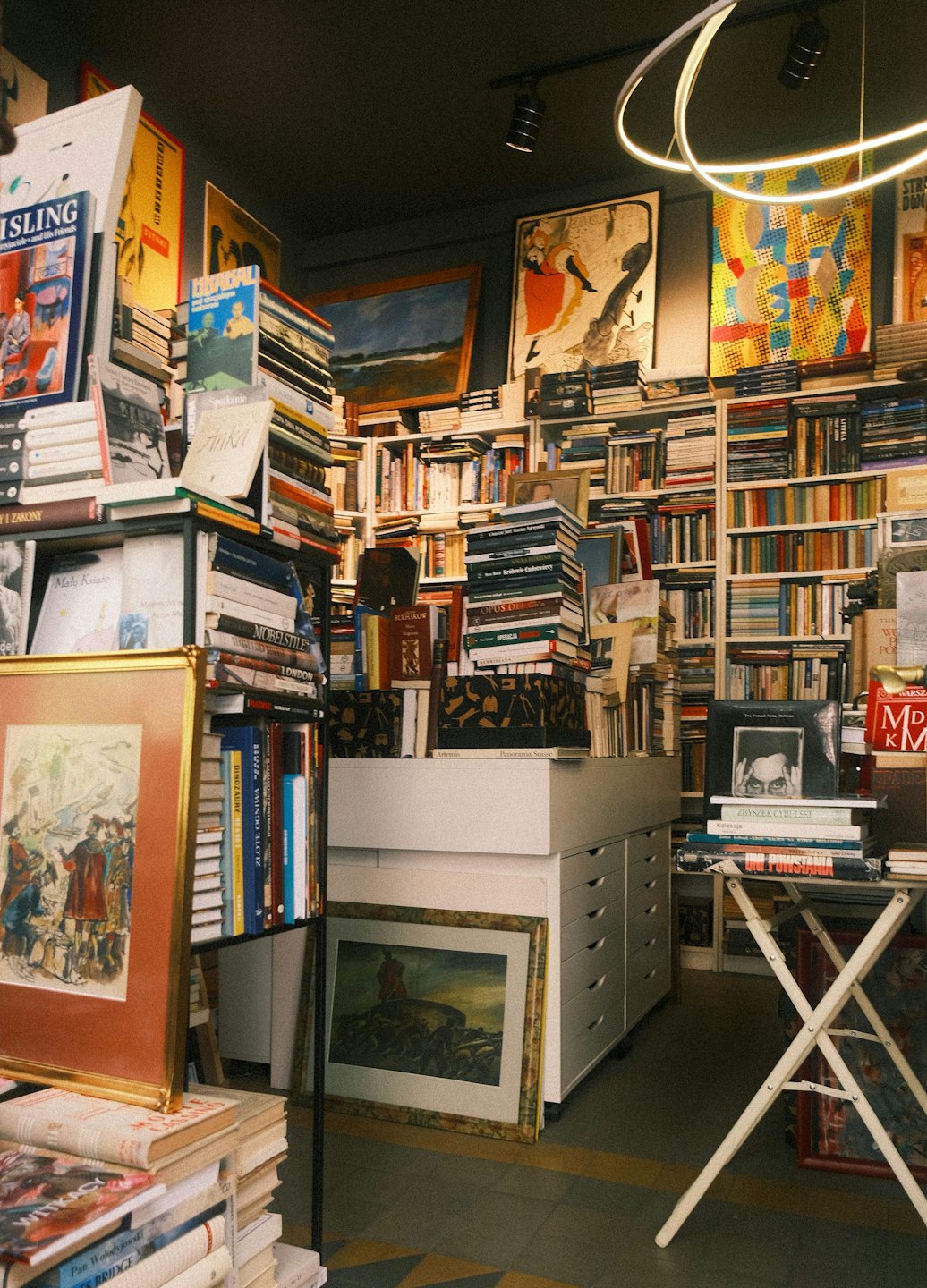 Vintage bookstore filled with overflowing shelves and antique furniture.